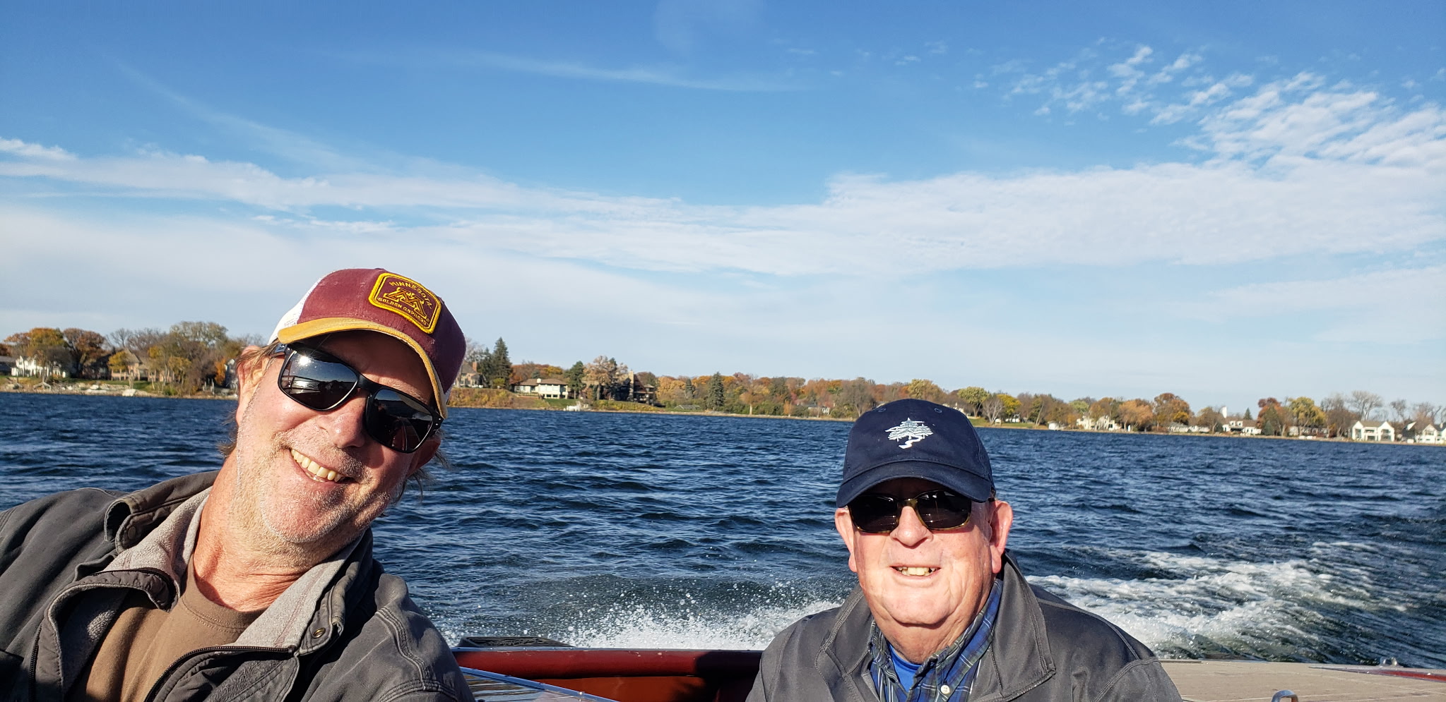 Andy Williamson and a friend out on a Minnesota lake on a classic wooden boat.