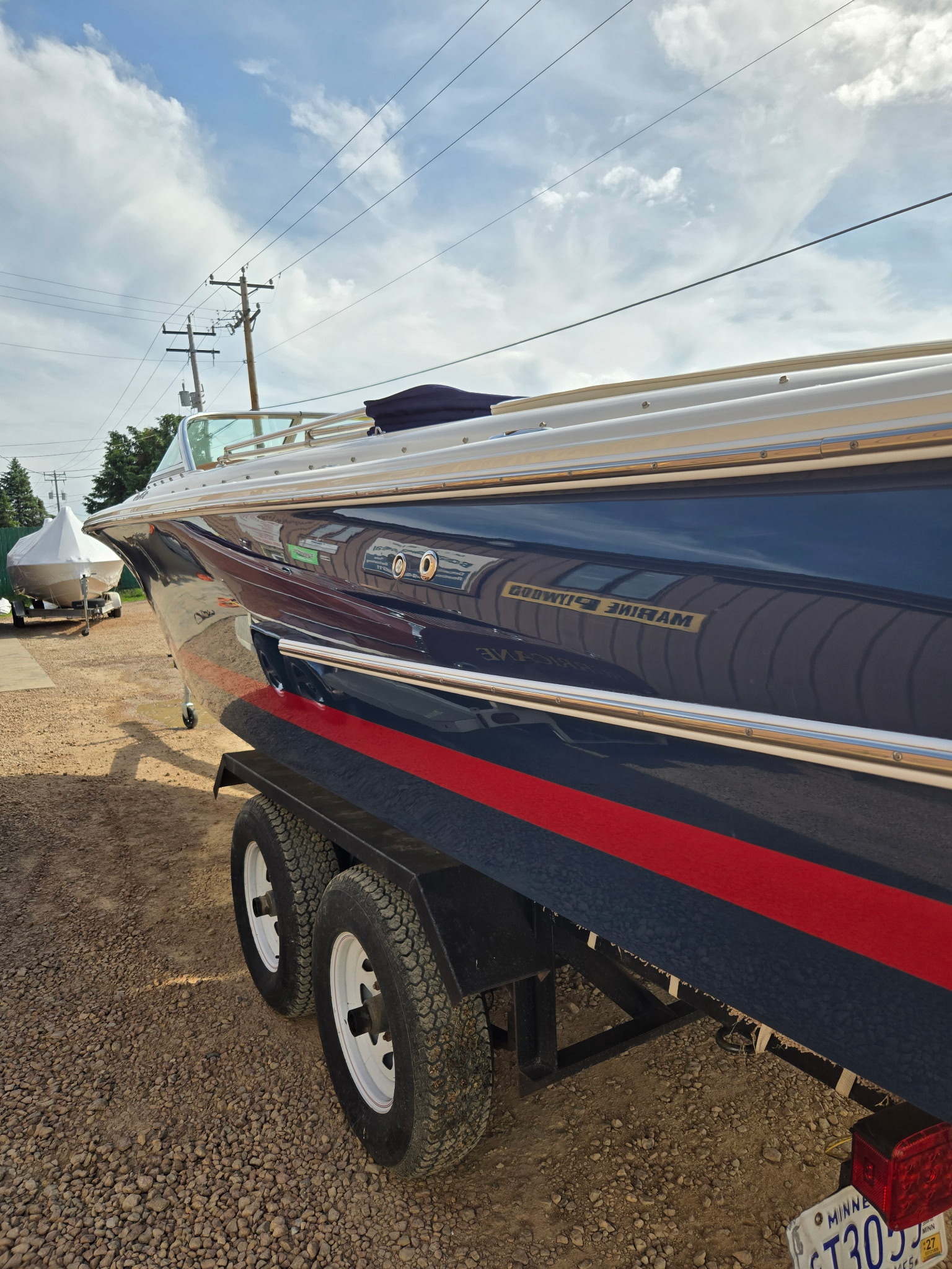 Mariner boat on trailer at Midwest Boat Appeal, ready for service.