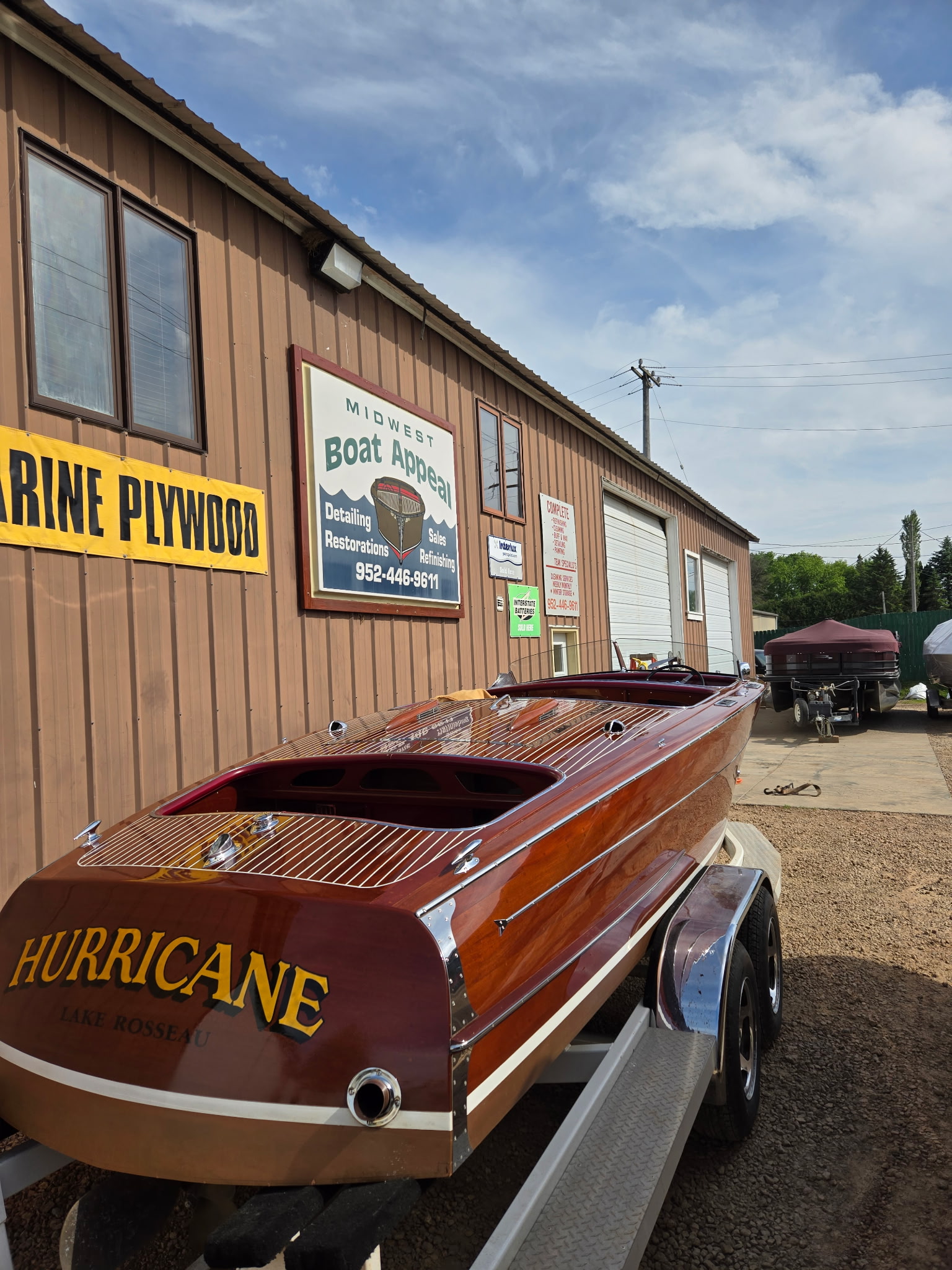Classic wooden boat in front of Midwest Boat Appeal shop, St. Bonifacius MN.